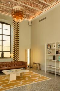 a living room with a couch and a table at Hôtel du Parc in Arles