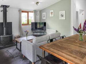 a living room with a couch and a table at Torridge Lodge - Ukc9517 in Sheepwash