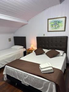 a bedroom with two beds in a room at Pousada Mineira in Ouro Preto