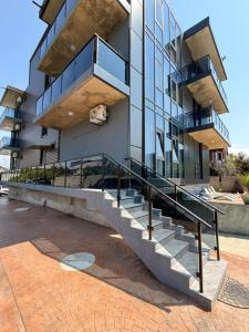 a building with a staircase in front of it at ,,KaKalo'' Apartments in Kobuleti