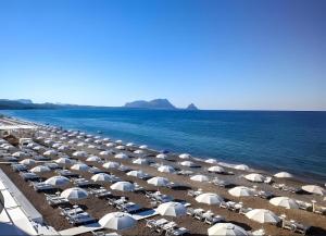 a row of umbrellas and chairs on a beach at Sicilian Sea Breeze - Apartment in Bagheria