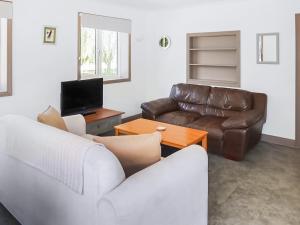 a living room with a couch and a television at Teal - Uk41036 in Marston