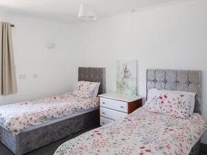 a bedroom with two beds and a dresser at Teal - Uk41036 in Marston +13 photos
