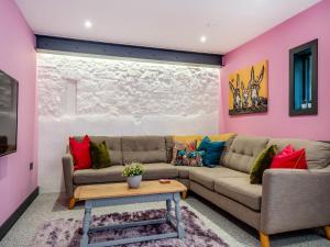 a living room with a couch and a table at The Hideaway in Yarmouth