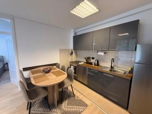 a kitchen with a table and chairs and a sink at Valverde Apartment Vlašić in Šišava