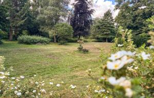 a garden with white flowers in the grass at 2 Bedroom Nice Home In Stenlille in Stenlille