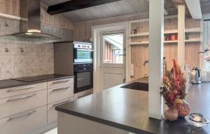 a kitchen with a counter top and a stove top oven at 2 Bedroom Nice Home In Stenlille in Stenlille