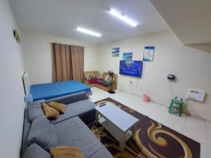 a living room with a couch and a table at Friends Hotel Apartments in Ajman 