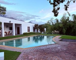 a swimming pool in the yard of a house at The Oak Cottage in Wellington