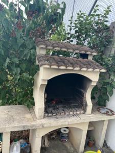 a outdoor oven with a roof on top of it at Entre Paris et Normandie in Mantes-la-Ville