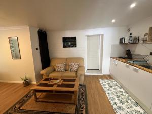 a living room with a couch and a table at Entre Paris et Normandie in Mantes-la-Ville