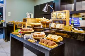 a bakery counter with different types of cakes and pastries at Aera Rio de Janeiro Copacabana in Rio de Janeiro