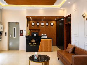 a lobby with a waiting room with clocks on the wall at Elite Creek Clifton in Karachi
