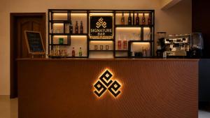 a bar with a sign on the counter of a restaurant at Elite Creek Clifton in Karachi