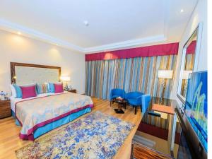 a hotel room with a bed and a television at Rixos Premium Seagate in Sharm El Sheikh