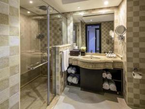 a bathroom with a sink and a shower at Rixos Premium Seagate in Sharm El Sheikh