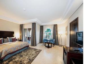 a hotel room with a bed and a television at Rixos Premium Seagate in Sharm El Sheikh +151 photos