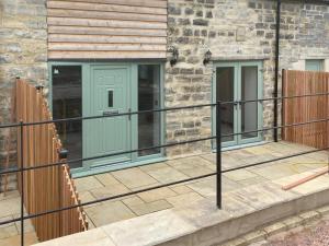 a balcony with a green door on a building at The Mill House Uk47418 in Curry Mallet