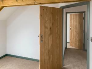a room with a wooden door and a hallway at The Mill House Uk47418 in Curry Mallet +2 photos