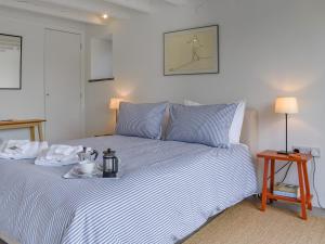 a bedroom with a bed with a tray of food on it at The Granary - Uk50401 in Llanstephan