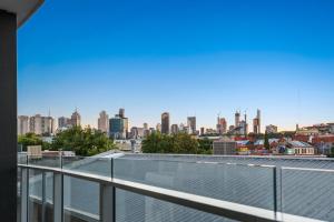 a view of the city from the roof of a building at District Apartments Fitzroy in Melbourne