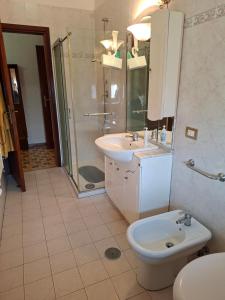 a bathroom with a toilet and a sink and a shower at la casa di LILLY con wi fi in Avellino