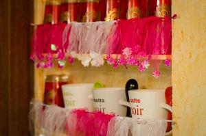 a bunch of coffee cups are on a shelf at Ecrin du Ségala - Roulotte insolite in Tauriac-de-Naucelle