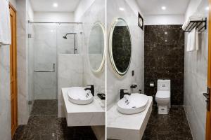 a bathroom with a sink and a toilet and a mirror at Elite Creek Clifton in Karachi +10 photos