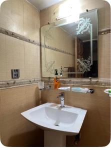 a bathroom with a white sink and a mirror at 4Bdr Spacious Hill View Central E 11 TV Netflix in Islamabad +22 photos