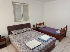 a bedroom with two beds and a window and a bed sidx sidx sidx at Zorica in Rafailovici