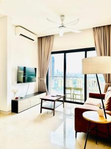 a living room with a couch and a table at Lucentia Residence BBCC Modern City View Stay in Kuala Lumpur +55 photos