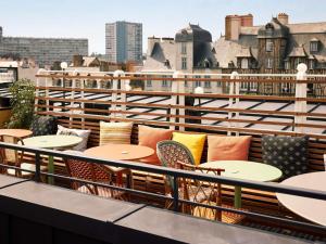 a row of tables and chairs on a balcony at Mama Shelter Rennes in Rennes