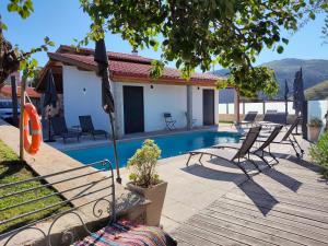 a villa with a pool and a house at Casa da Pinha in Ponte da Barca