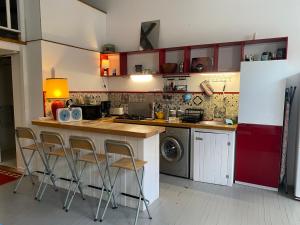 a kitchen with a counter and stools in it at Oasis de Vic in Vic-Fezensac