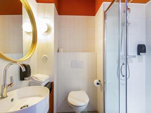 a bathroom with a sink and a toilet and a shower at ibis Styles Salon de Provence in Salon-de-Provence +64 photos