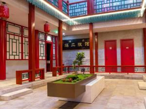 a building with a fountain in the middle of a room at Mercure Beijing Tiananmen Square Qianmen Street in Beijing