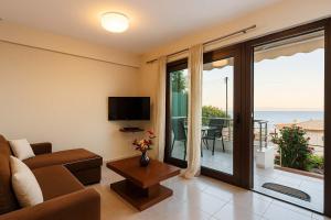 a living room with a couch and a view of the ocean at Seaside Getaway - Aelia Villa's Dreamy Paradise in Petalidi
