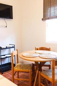 a table and chairs in a room with a tv at Casa Veronica in Arona