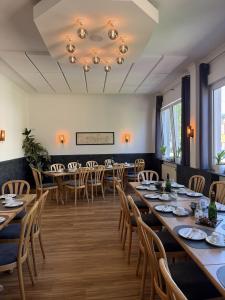 a dining room with long tables and chairs at Hotel & Restaurant Brühler Hof in Wintrich