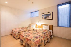 Postel nebo postele na pokoji v ubytování Sundance Resort Yamanakako