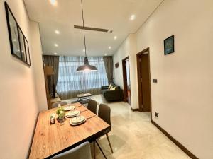a dining table in a room with a living room at Sky Apart-Hotel klcc in Kuala Lumpur