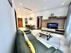a living room with a couch and a tv at Sky Apart-Hotel klcc in Kuala Lumpur