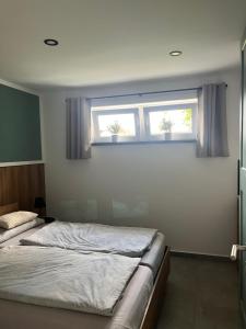 a bedroom with two beds and a window at Ferienhaus Friedrich 22 in Kolkwitz