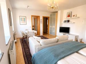 a living room with a couch and a tv at Schlossapartments Wolfsberg in Wolfsberg