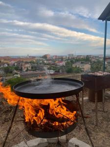 a fire pit with flames and a bbq at Sea Panorama in Karolino-Buhaz