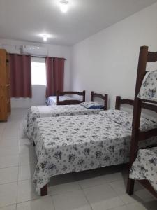 a bedroom with two beds and a window at Hostel Família Carvalho in Barreirinhas +36 photos
