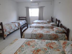 a group of four beds in a room at Hostel Família Carvalho in Barreirinhas
