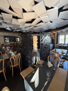 a restaurant with tables and chairs and a ceiling at Hotel & Restaurant Brühler Hof in Wintrich +35 photos