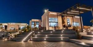 a building with stairs in front of it at night at Zahra-Northed Chalet in El Alamein
