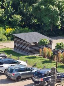 a building with cars parked in a parking lot at Kameralny Apartament w Centrum in Szczytno